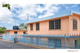 House with solar panels and small house in Utuado